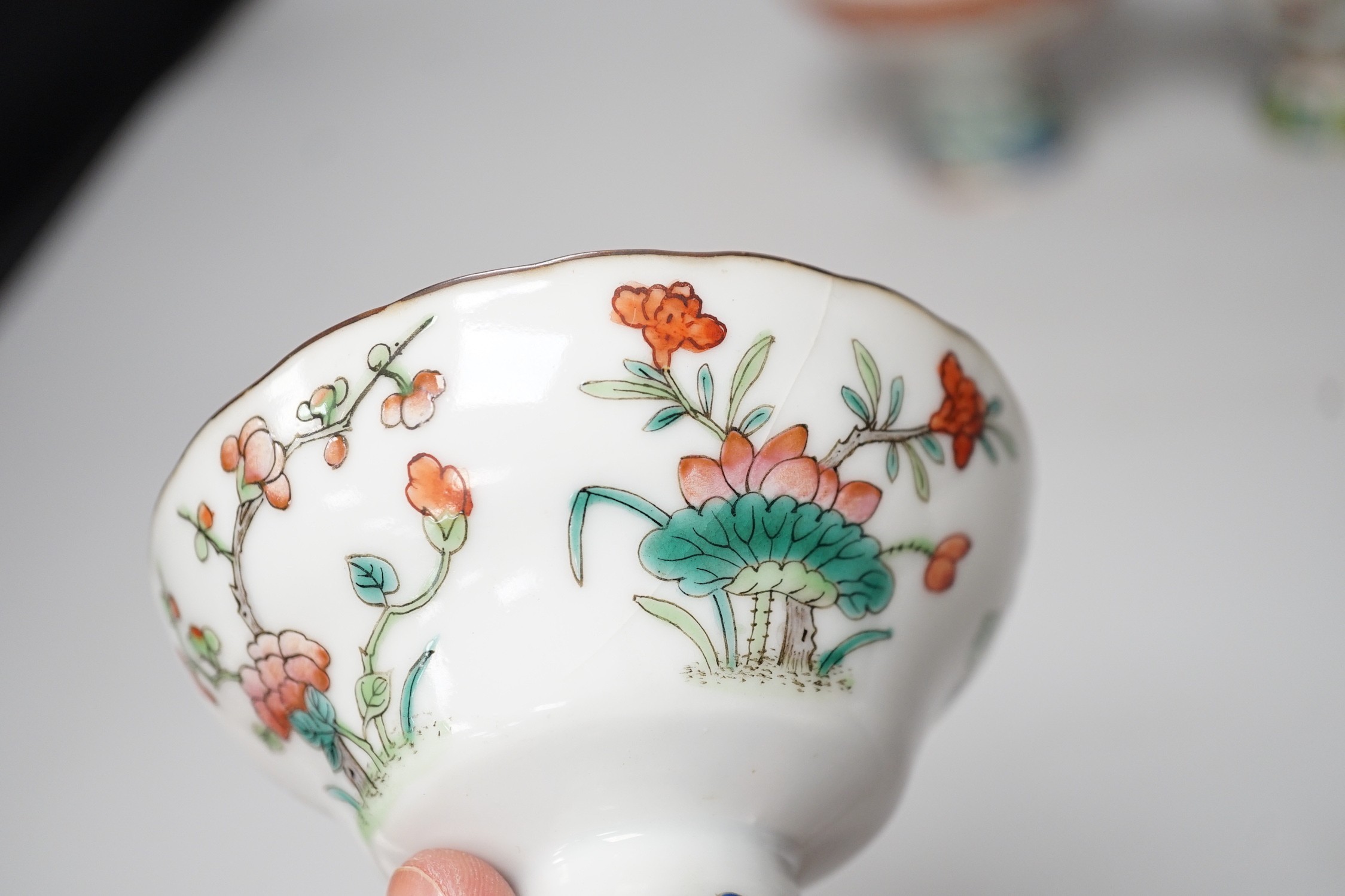 Three 19th century Chinese stem cups, painted with insects, flowers, bats and peaches, largest 9cm